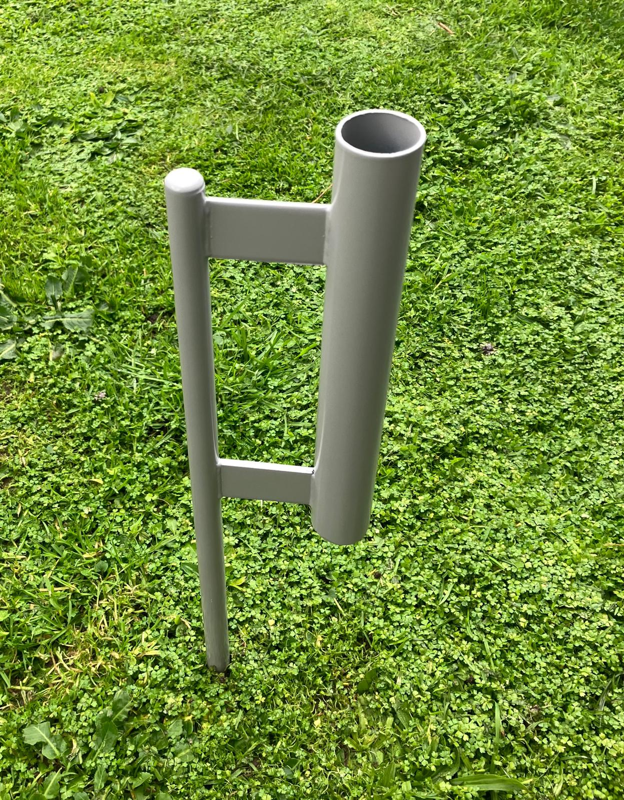 Gray metal stand on a grassy background